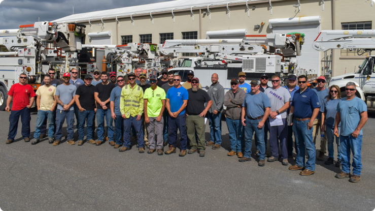 Employee working on power lines in safety gear